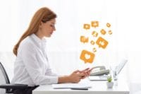 Businesswoman-Engaging-with-Social-Media-Sitting